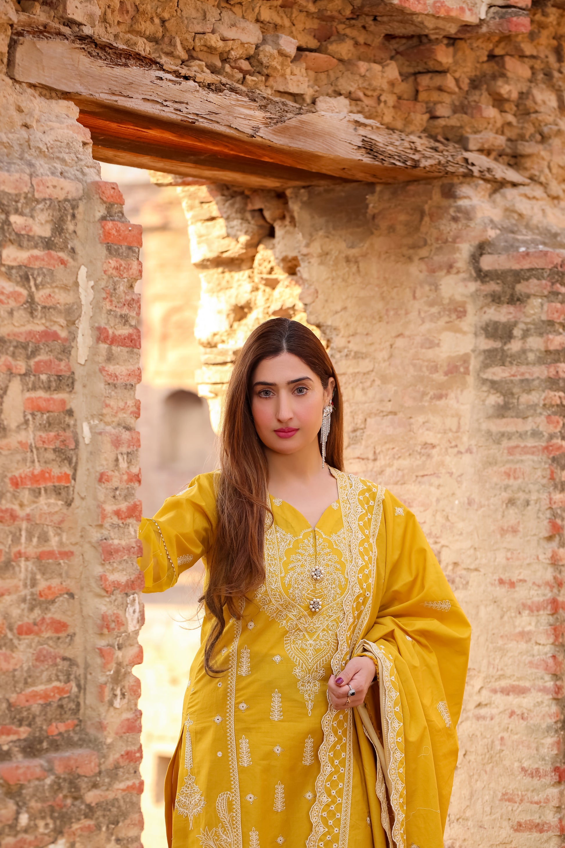 Saadia Ahmed LWSU-25CK306 ChikanKari Mustard Outfit with Intricate Embroidery in a Rustic Setting