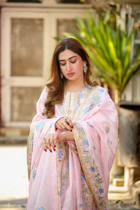 Elegant woman in Saadia Ahmed LWSU-25FE308 Embroidered Swiss Cotton outfit with floral designs and embellishments