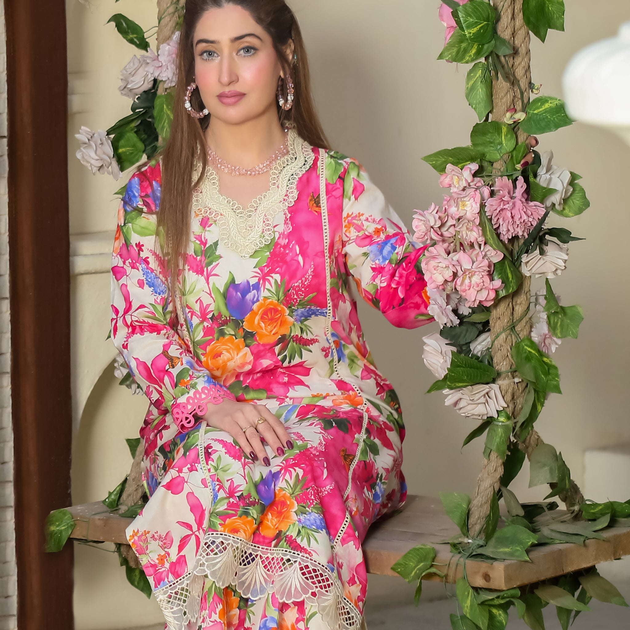 Saadia Ahmed LWSU-25P208 2-Pcs Printed Lawn Dress with Floral Design on a Model Sitting on a Swing