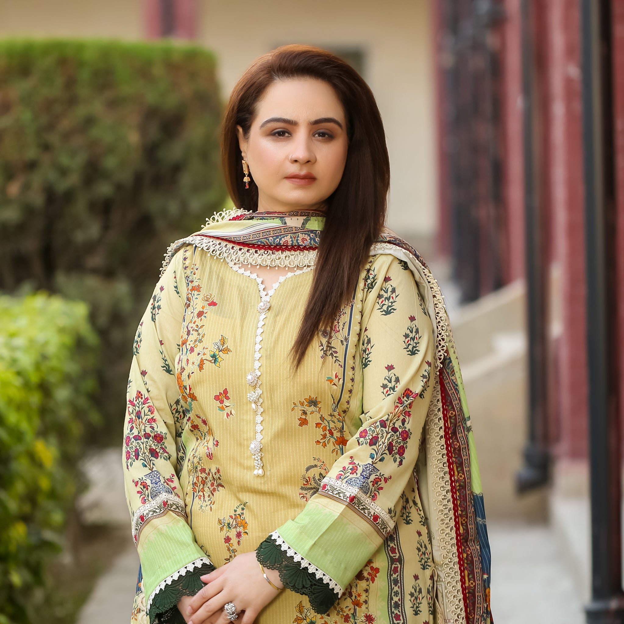 Model wearing Saadia Ahmed LWSU-25P311 3-Pcs Printed Lawn Suit in a garden setting with a stylish design